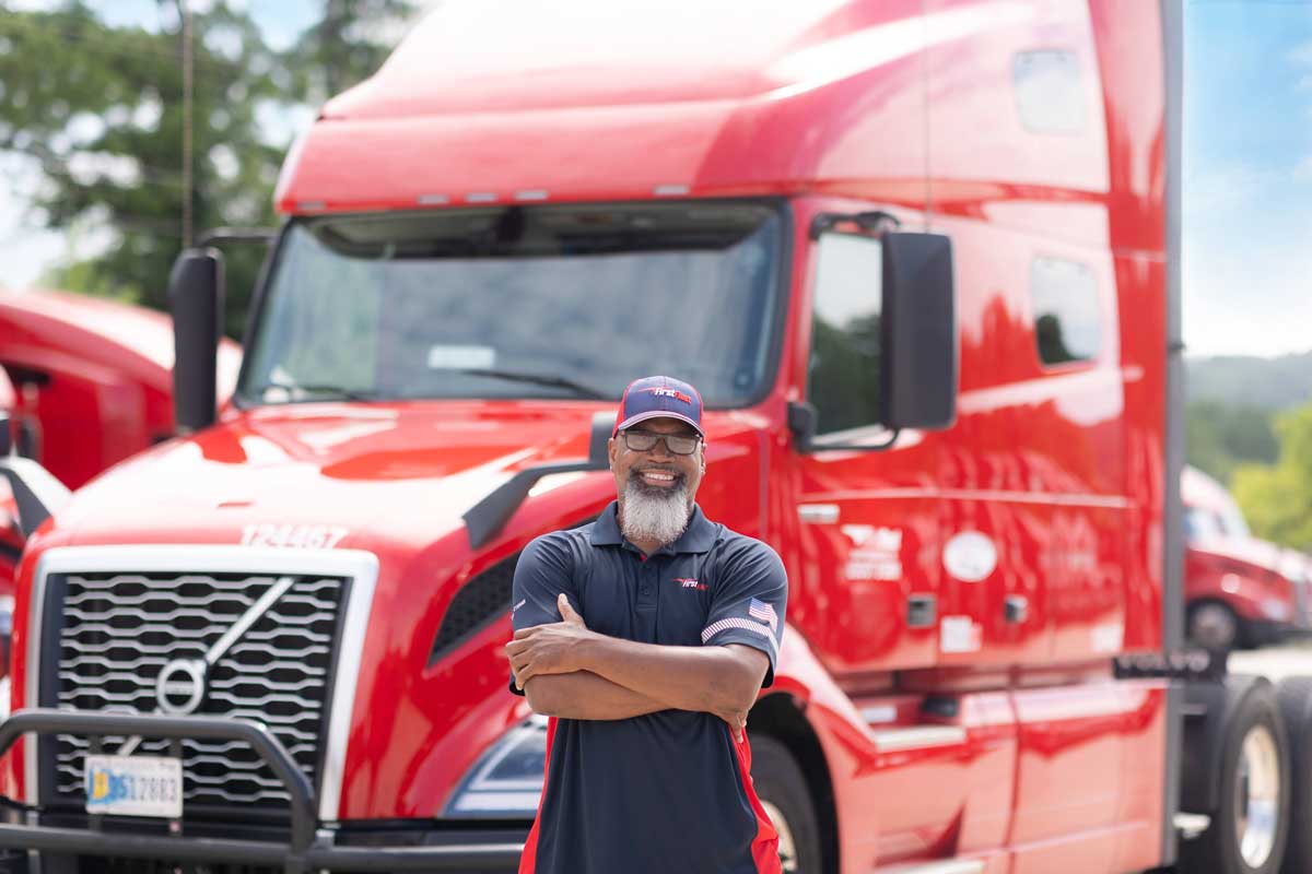 A FirstFleet driver leaning against his truck